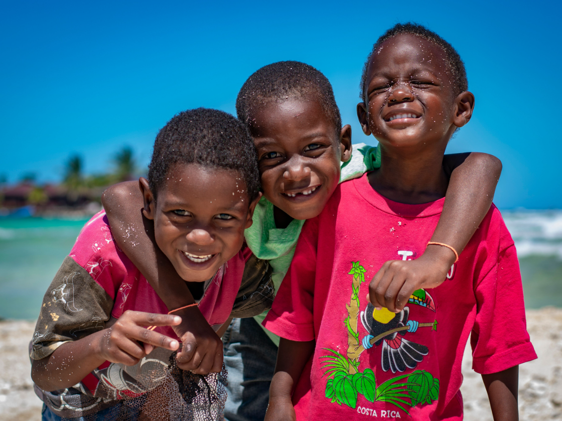 Three children laughing together